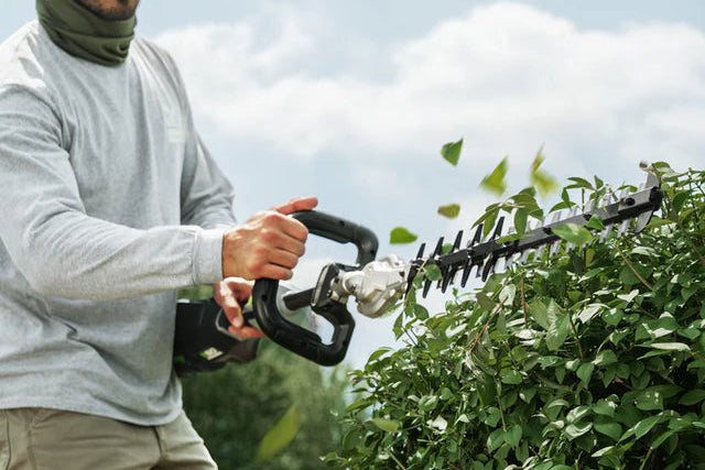 Trimming bushes with an EGO cordless hedge trimmer